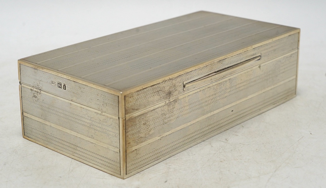 A George V engine turned silver mounted rectangular cigarette box, Padgett & Braham Ltd, London, 1926, 17.8cm. Condition - fair to good